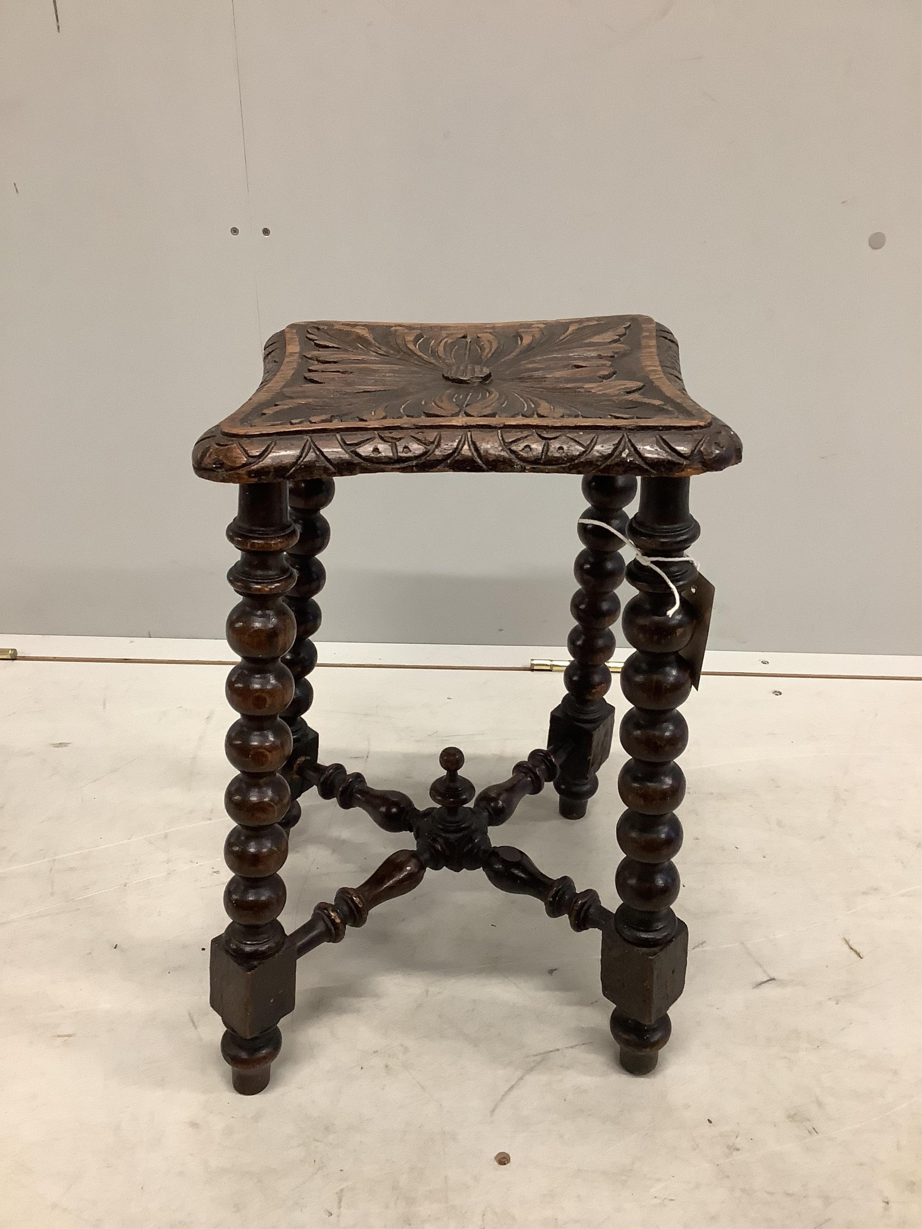 A Victorian carved oak bobbin turned stool, bears Bruce & Co. trade label, height 46cm. Condition - fair